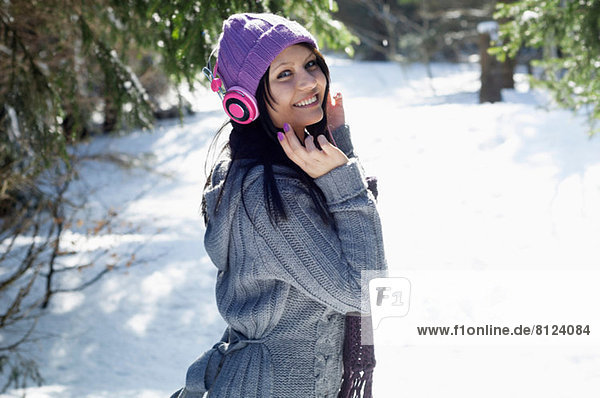 Portrait of young female listening to headphones