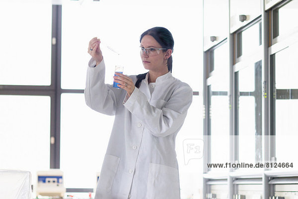Female scientist holding sample and pipette