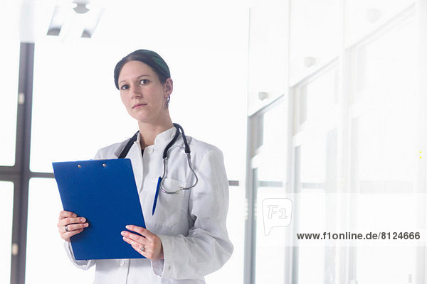 Portrait of female doctor with clipboard