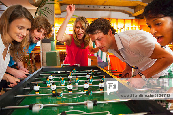 Group of friends playing table football