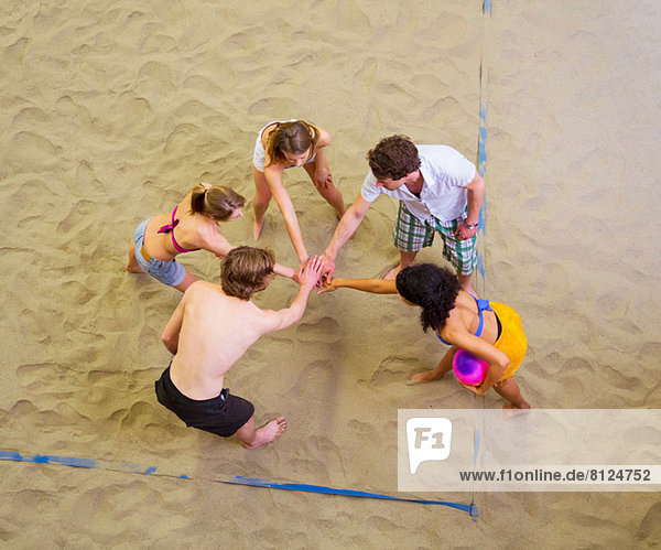 Aerial view of friends team talk at indoor beach volleyball
