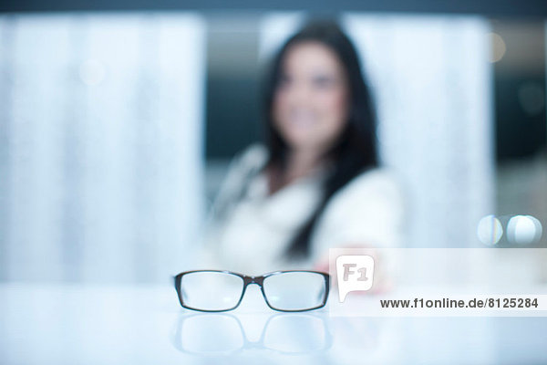 Woman and a pair of eyeglasses