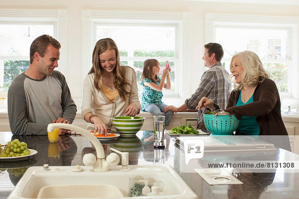 Three generation family in kitchen preparing food