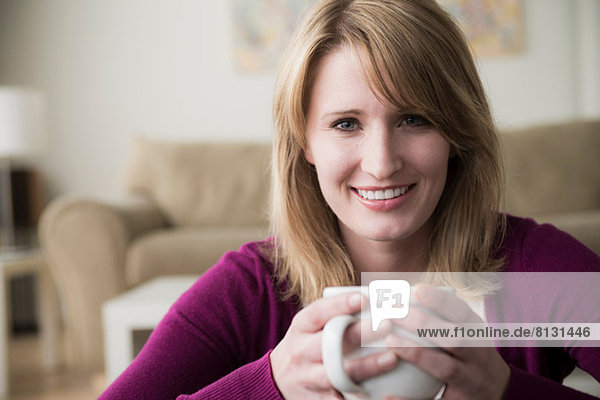 Young woman holding coffee