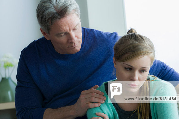 Father comforting teenage daughter