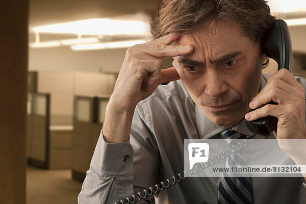 Frowning man on telephone