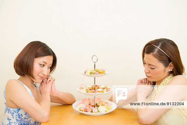 Two women looking at assortment of confectioneries