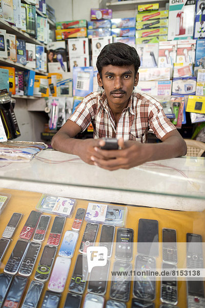 Mobile phone seller in his shop