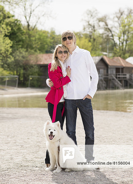 Germany  Bavaria  Portrait of couple standing with dog