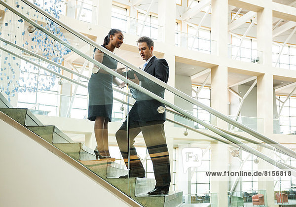 Business people talking on staircase