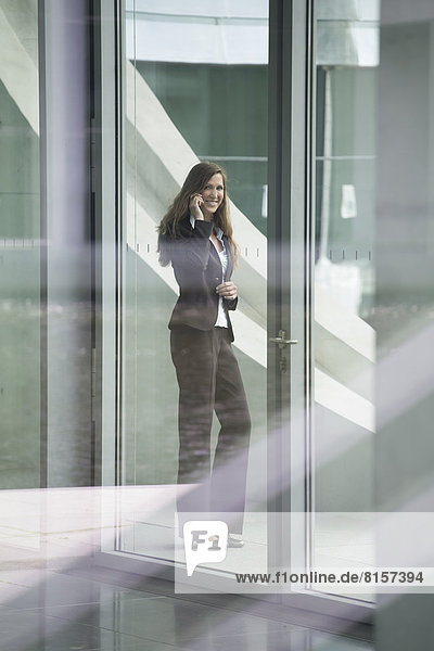 Portrait of businesswoman talking on smart phone  smiling