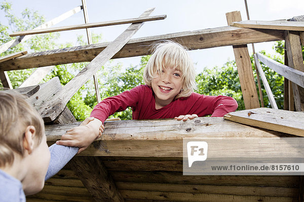 Germany  North Rhine Westphalia  Cologne  Boys playing in playground  smiling