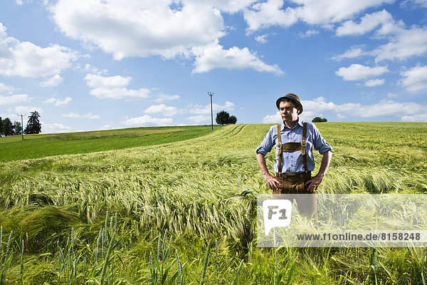 Germany  Bavaria  Farmer standing in field