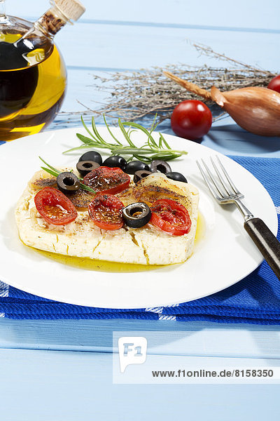 Feta  tomatoes  olives and rosemary in plate with fork