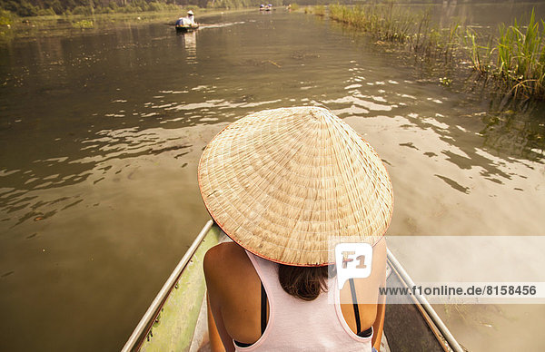 Vietnam  Ninh Binh  Female tourist at tour rowing boat