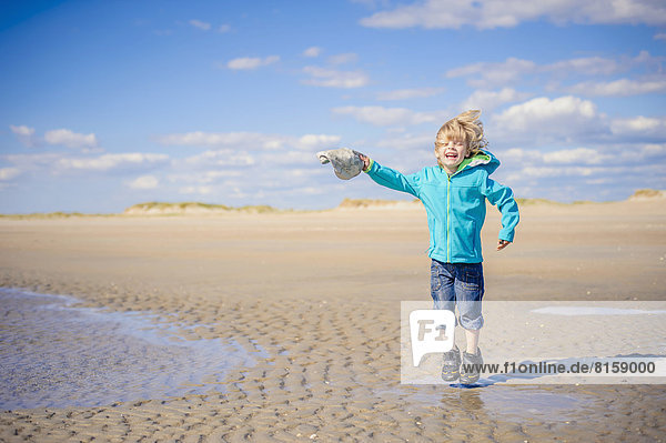 Denmark  Romo  Boy jumping at North Sea  smiling