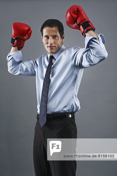 Portrait of mature man wearing boxing glove  smiling
