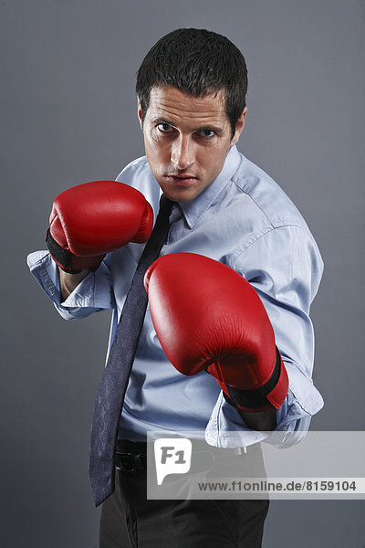 Portrait of mature man wearing boxing glove