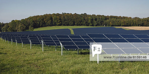 Germany  Bavaria  Solar panels on grass against sky