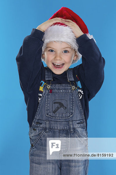 Portrait of boy with santa hat  smiling