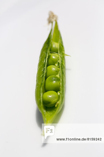 Green peas on white background  close up