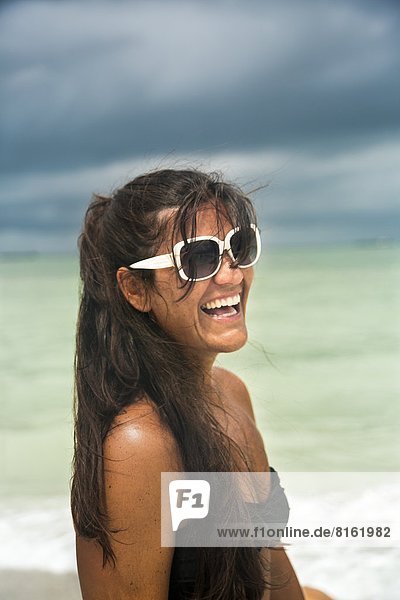 Laughing young woman on beach