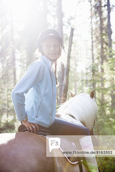 Girl on horse looking away