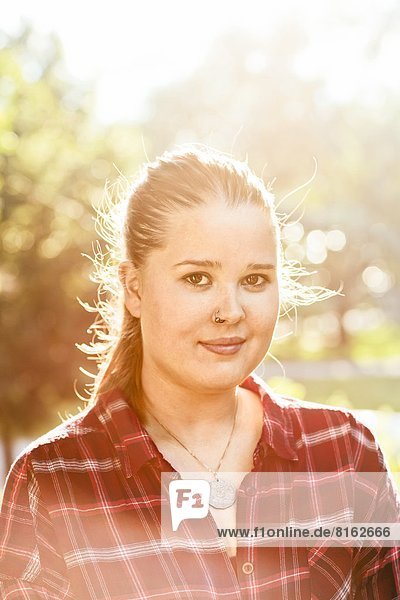 Portrait of young woman in garden