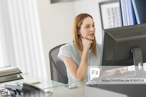 Business woman using computer in office