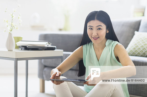 Portrait of woman using tablet pc at home