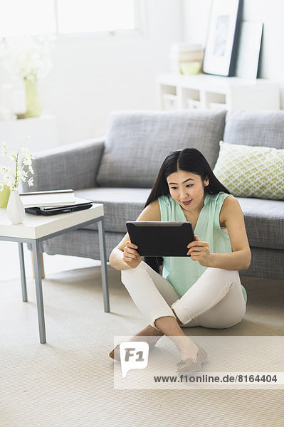 Woman using tablet pc at home