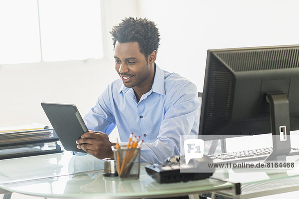 Businessman using tablet PC in office