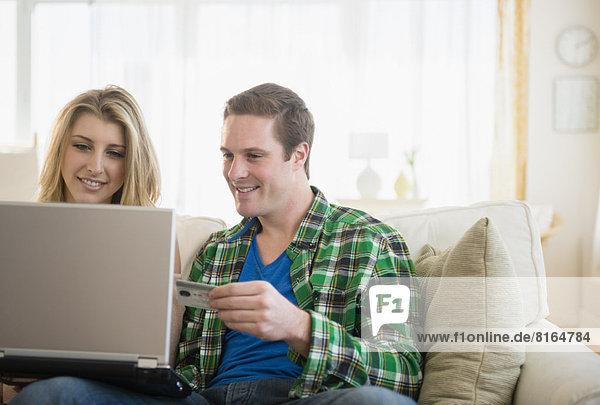 Couple using laptop  shopping online