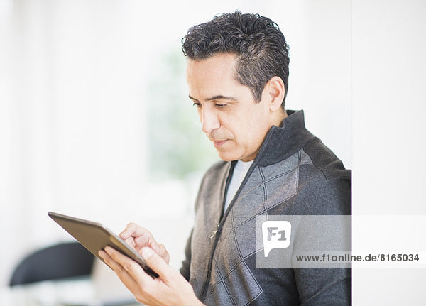 Portrait of man holding digital tablet
