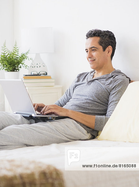View of mature man using laptop at home