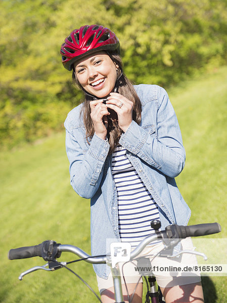 Portrait of mid adult woman with bicycle