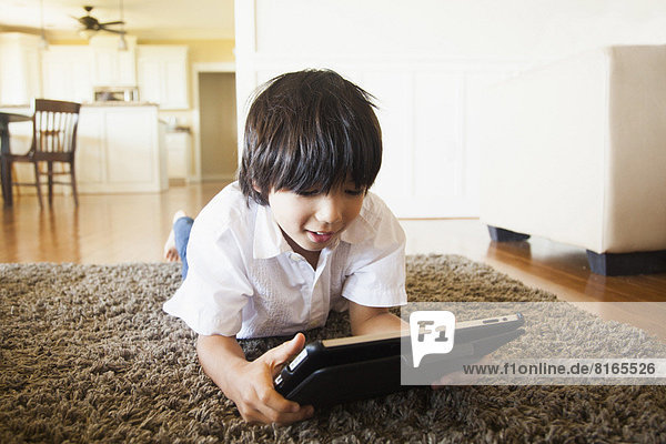 Boy (8-9) using digital tablet