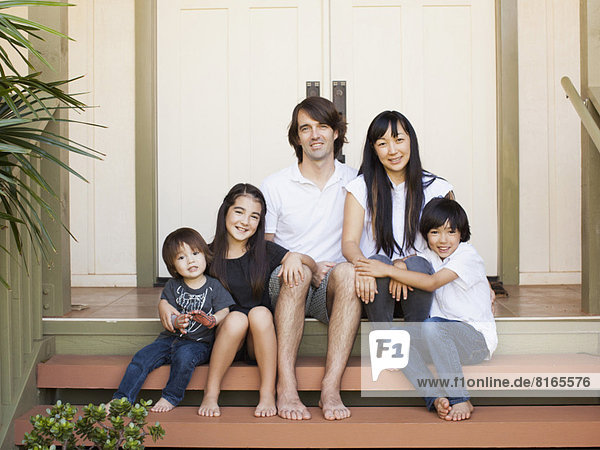 Portrait of family with three kids (2-3  8-9)