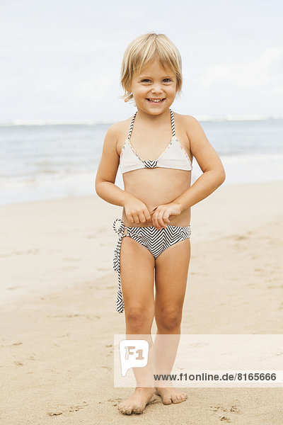 Portrait of girl (2-3) standing on beach