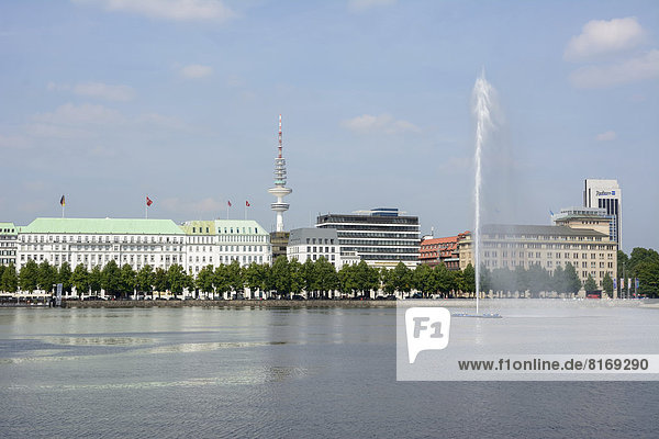 View over the Inner Alster Lake with Alster Fountain towards the street of Neuer Jungfernstieg  Hotel Vier Jahreszeiten or Four Seasons Hotel and the television tower at the rear