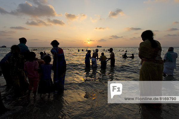 Hindu pilgrims taking a holy bath in the sea at sunrise  at the Ghat Agni Theertham
