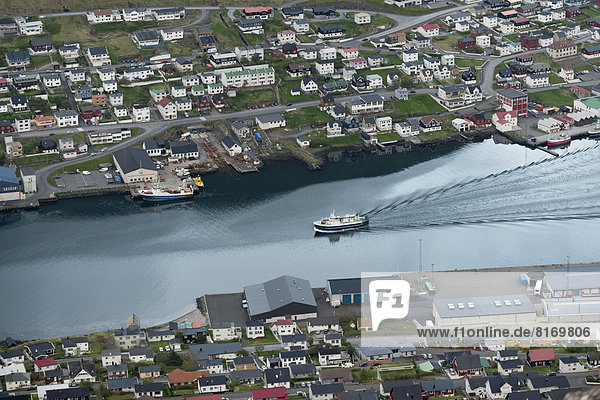 Departing ferry  port and houses