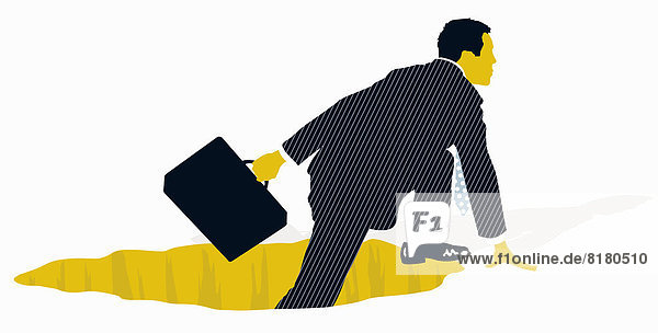 Businessman with briefcase climbing out of hole