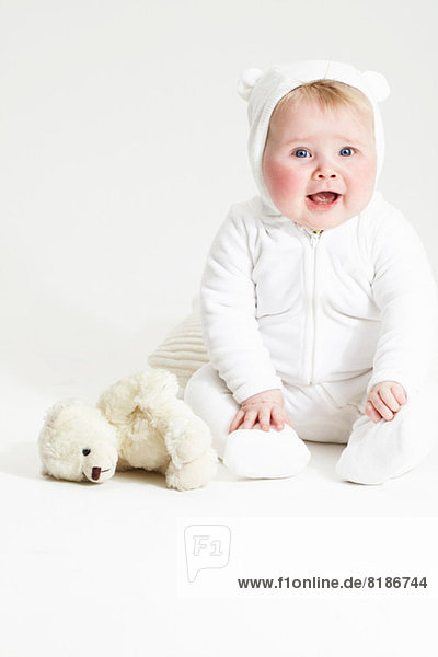 Portrait of smiling baby girl and teddy bear