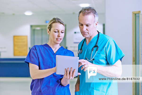 Doctor and surgeon looking at medical records