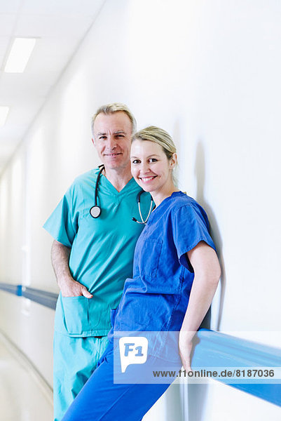 Surgeon and doctor standing in corridor