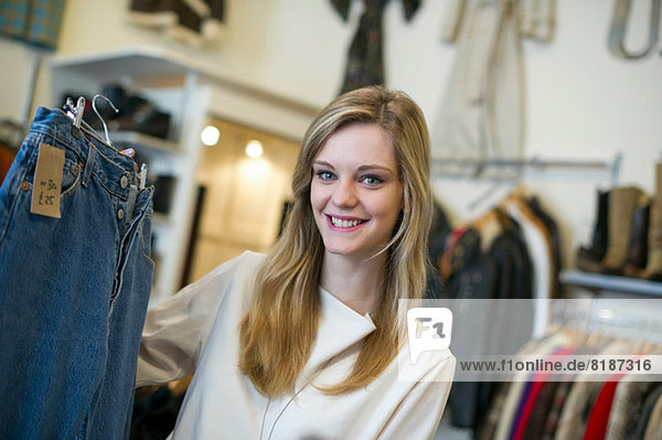 Woman looking at pair of jeans