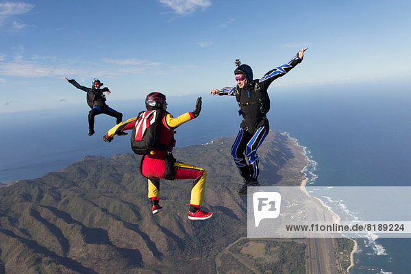Three formation skydivers free falling