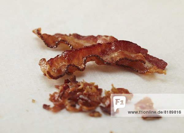 Two Crispy Strips of Bacon with Crumbled Bacon
