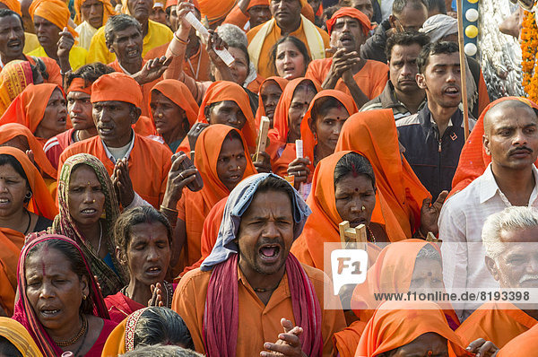 Prozession von in orangener Farbe gekleideten Gläubigen  während der Kumbha Mela